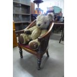 A vintage Teddy bear and chair