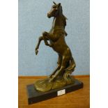 A bronze figure of a rearing stallion, on black marble plinth, 41cm