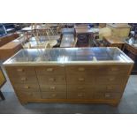 An oak sixteen drawer haberdashery shop cabinet, 92cms h, 180cms w, 60cms d