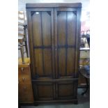 An early 20th Century oak press cupboard, 191cms h, 88cms w, 50cms d