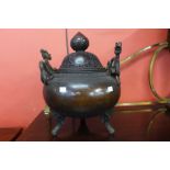 An oriental bronze two handled koro and cover, 45cm h