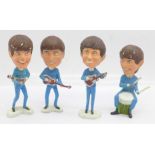 A set of four plastic Beatles figures
