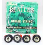 A packet of Hofner Beatles guitar strings and four 1960's Beatles rings