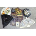 A papier-mache lacquered hand fan inlaid with mother of pearl, three fans, circular box, Art Nouveau