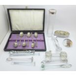 Nine glass knife rests, a set of plated Apostle spoons and two glass dressing table containers