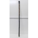 A Japanese ebonised bamboo walking cane, root finial, with finely carved decoration of two snakes, a