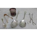 A pair of plated serving spoons, two pairs of sugar tongs, etc.