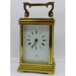 An English brass and four glass sided timepiece with key, the dial marked Poyser