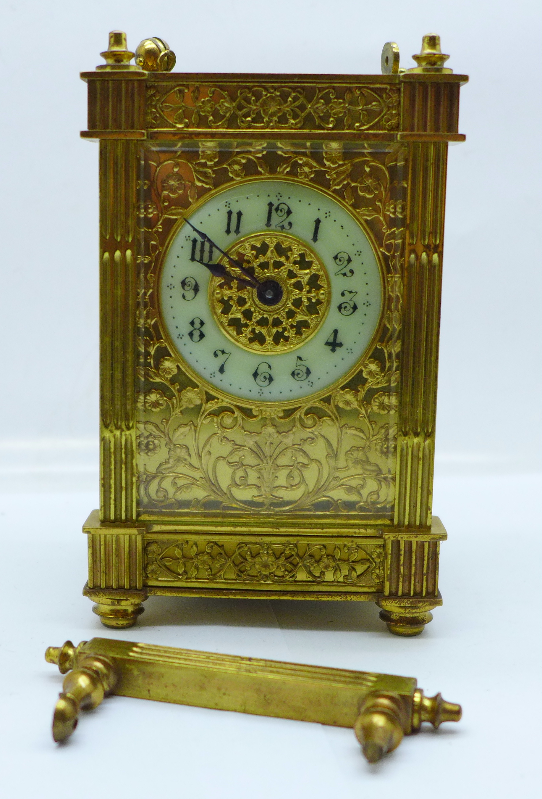 A brass and four glass sided mantel timepiece with pierced fretwork sides, a/f