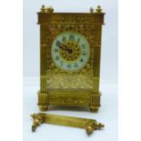 A brass and four glass sided mantel timepiece with pierced fretwork sides, a/f