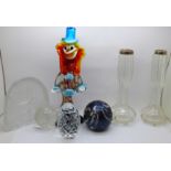 A pair of silver rimmed glass vases, a glass clown and four paperweights