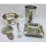 A WMF beaker, a pair of silver plated sugar bows, a porringer or wine taster, a silver plated