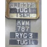 Six vintage metal and enamel car number plates; includes a pair, 'TUG1' and four others