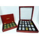 Two cased sets of Zippo lighters, eight brass and twenty mixed, all bearing mottos or motifs