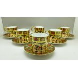 A set of six Royal Crown Derby 1128 pattern coffee cans and saucers