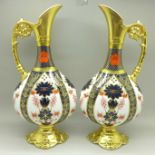 A pair of Royal Crown Derby 1128 pattern ewers, 25.5cm, (one with hairline crack on the handle)