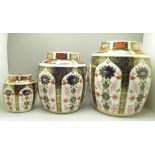 A graduated set of three Royal Crown Derby 1128 pattern ginger jars, largest stained inside