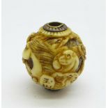 A Japanese Meiji period carved ivory ball/charm depicting animals, signed