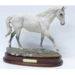 A Royal Doulton limited edition figure of Desert Orchid, 651 of 7500, on a wooden plinth, 32.5cm