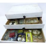 A wood cabinet of mixed watch parts and watch materials