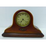 An inlaid mantel clock, brass bezel