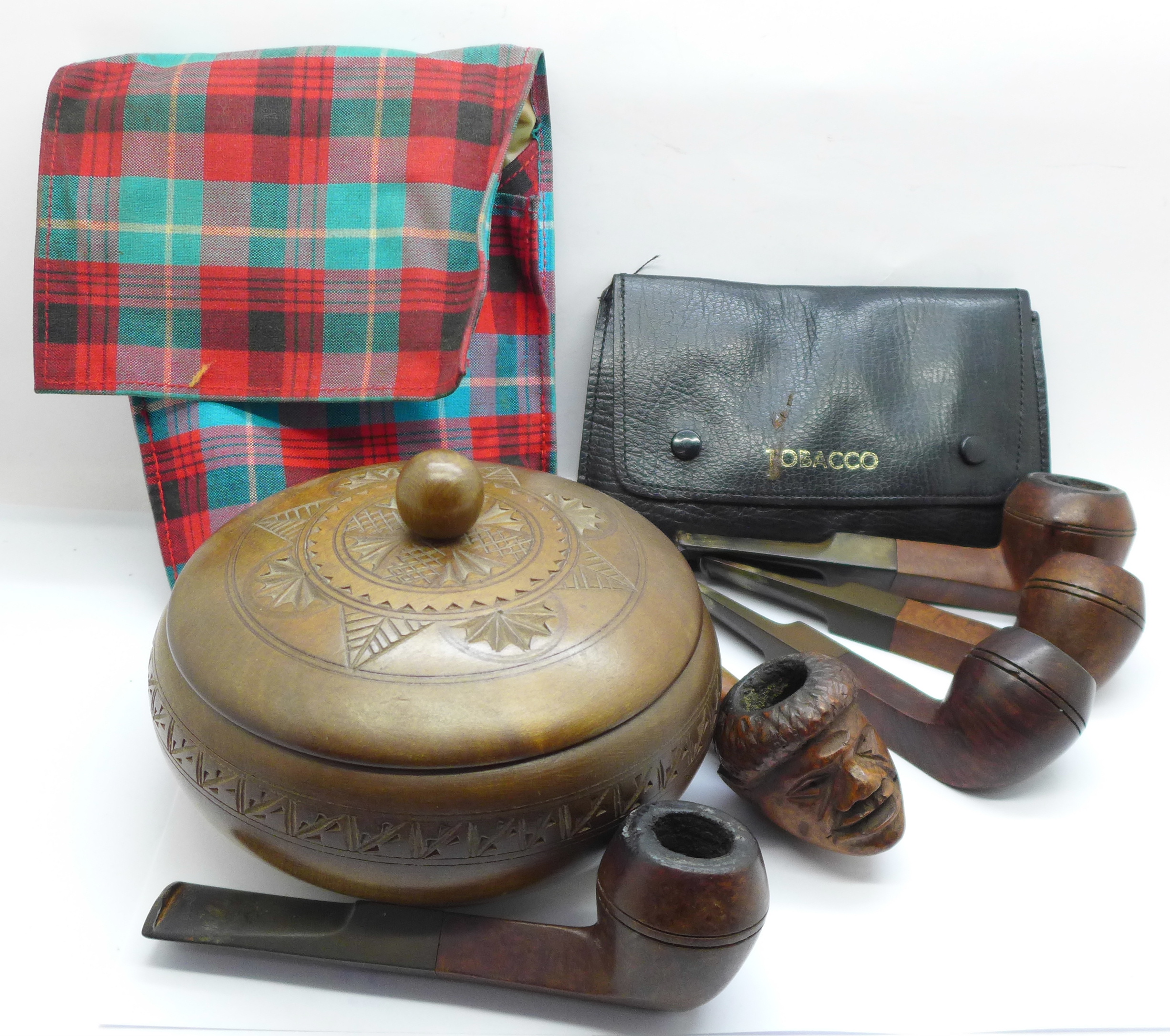 Five pipes including one with carved head, a tobacco pouch and a tobacco box