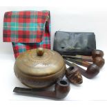 Five pipes including one with carved head, a tobacco pouch and a tobacco box