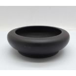 A small Wedgwood black basalt dish with impressed Wedgwood and Made in England marks