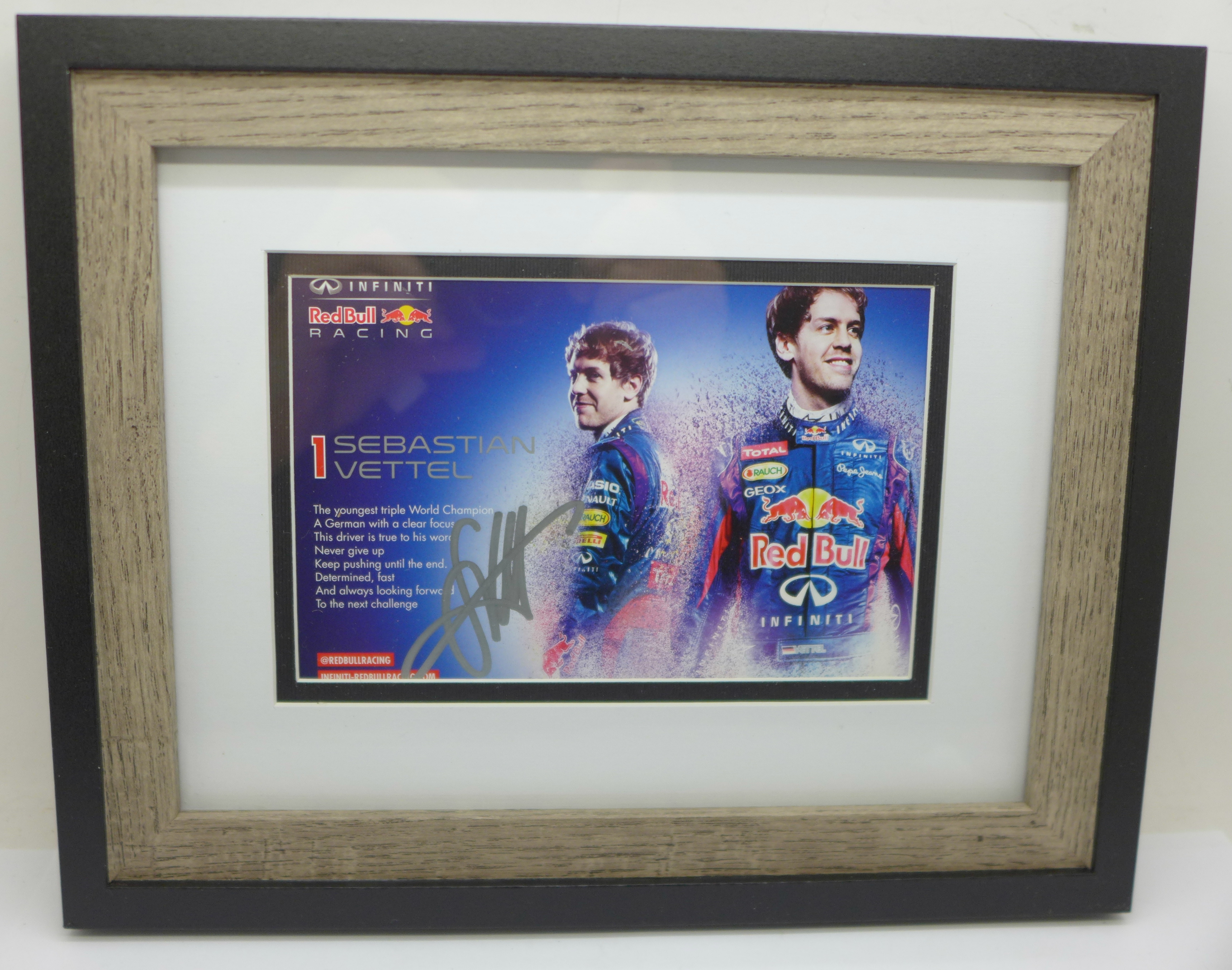 A framed signed photograph of triple Formula 1 World Champion Sebastian Vettel