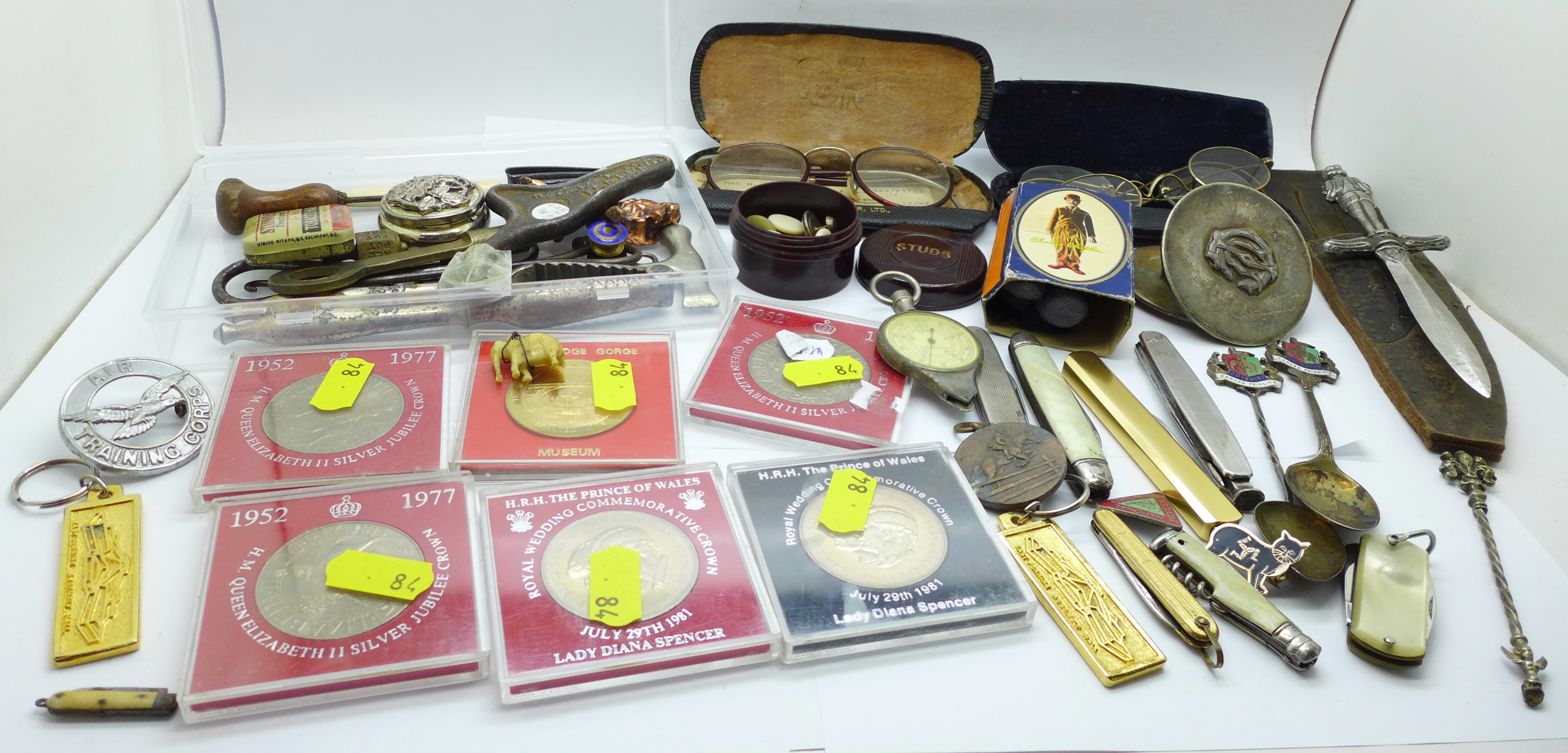 Three pairs of spectacles, penknives, commemorative crowns, souvenir spoons, etc.