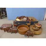 A box of assorted wooden items including fruit bowls and carved animals