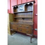 An Arts and Crafts oak dresser, 188cms h, 137cms w, 49cms d.