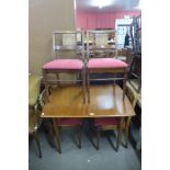 An oak extending dining table and four chairs