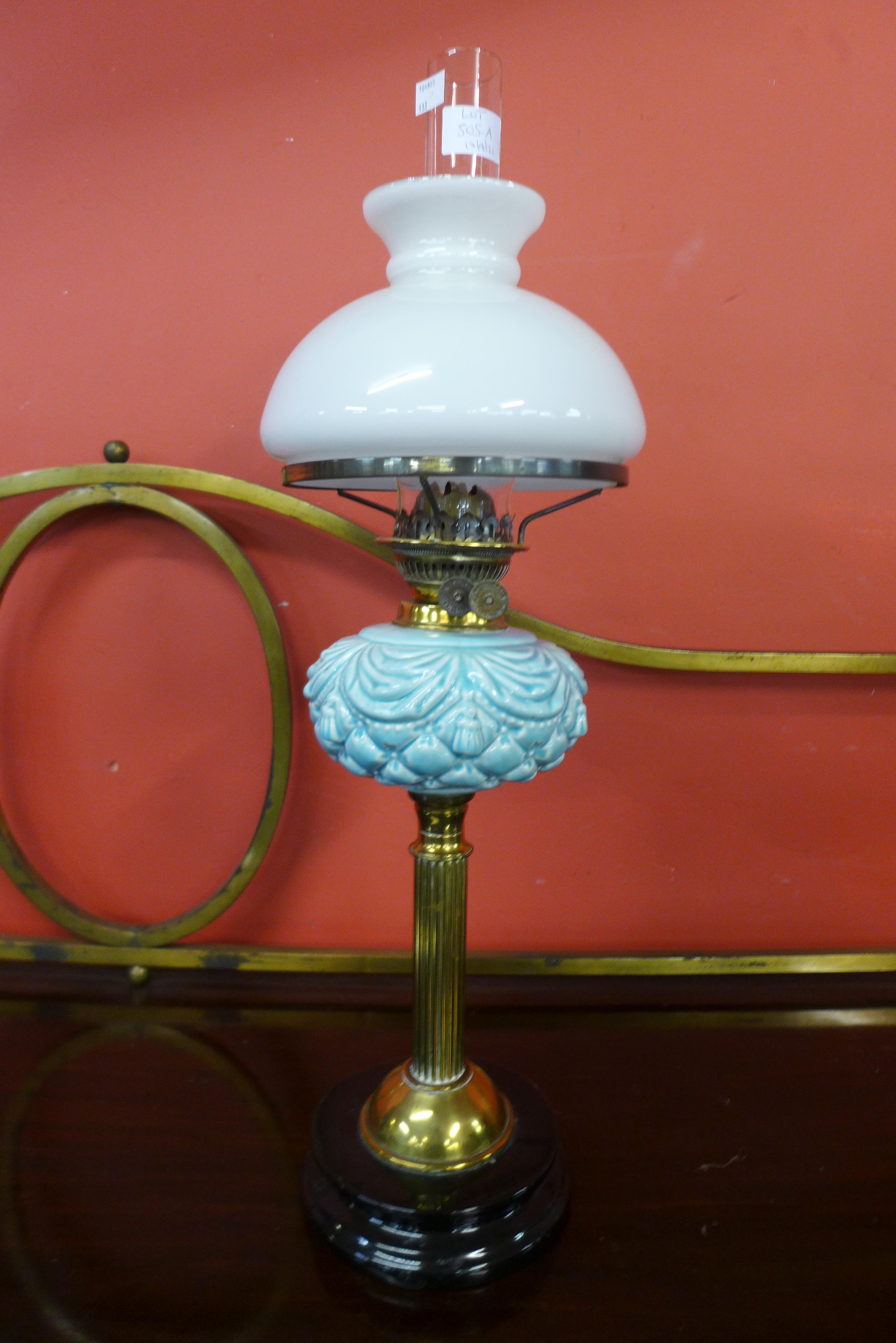 A Victorian brass and porcelain oil lamp