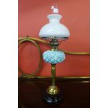 A Victorian brass and porcelain oil lamp