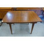 A teak extending dining table