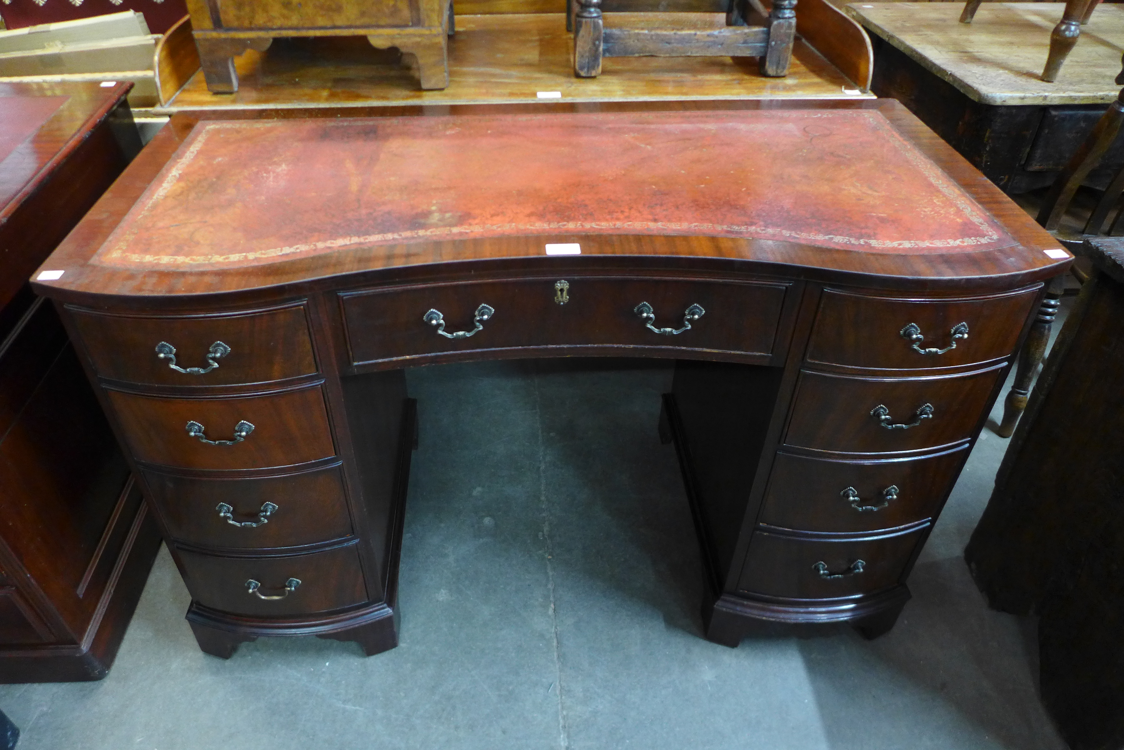 A mahogany kneehole desk, 76cms h, 120cms w, 56cms d.