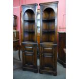 A pair of Titchmarsh & Goodwin Ipswich oak freestanding corner cabinets, 167cms h