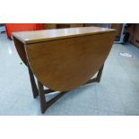 A teak drop-leaf table