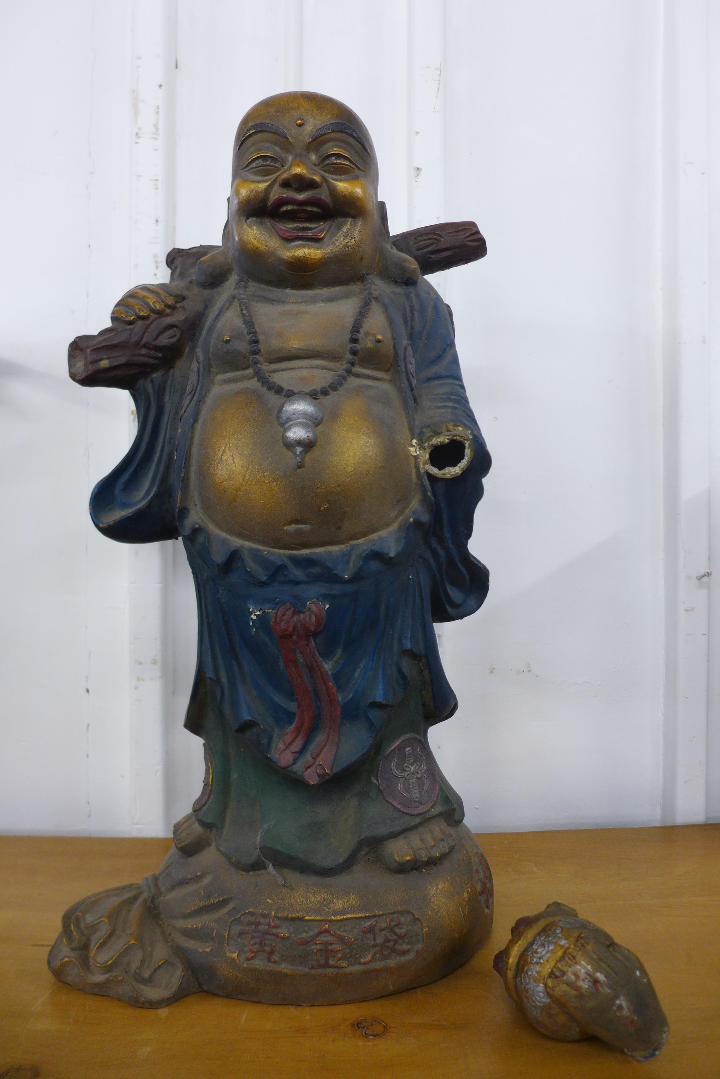 A large oriental painted cast metal Buddha, 78cms h