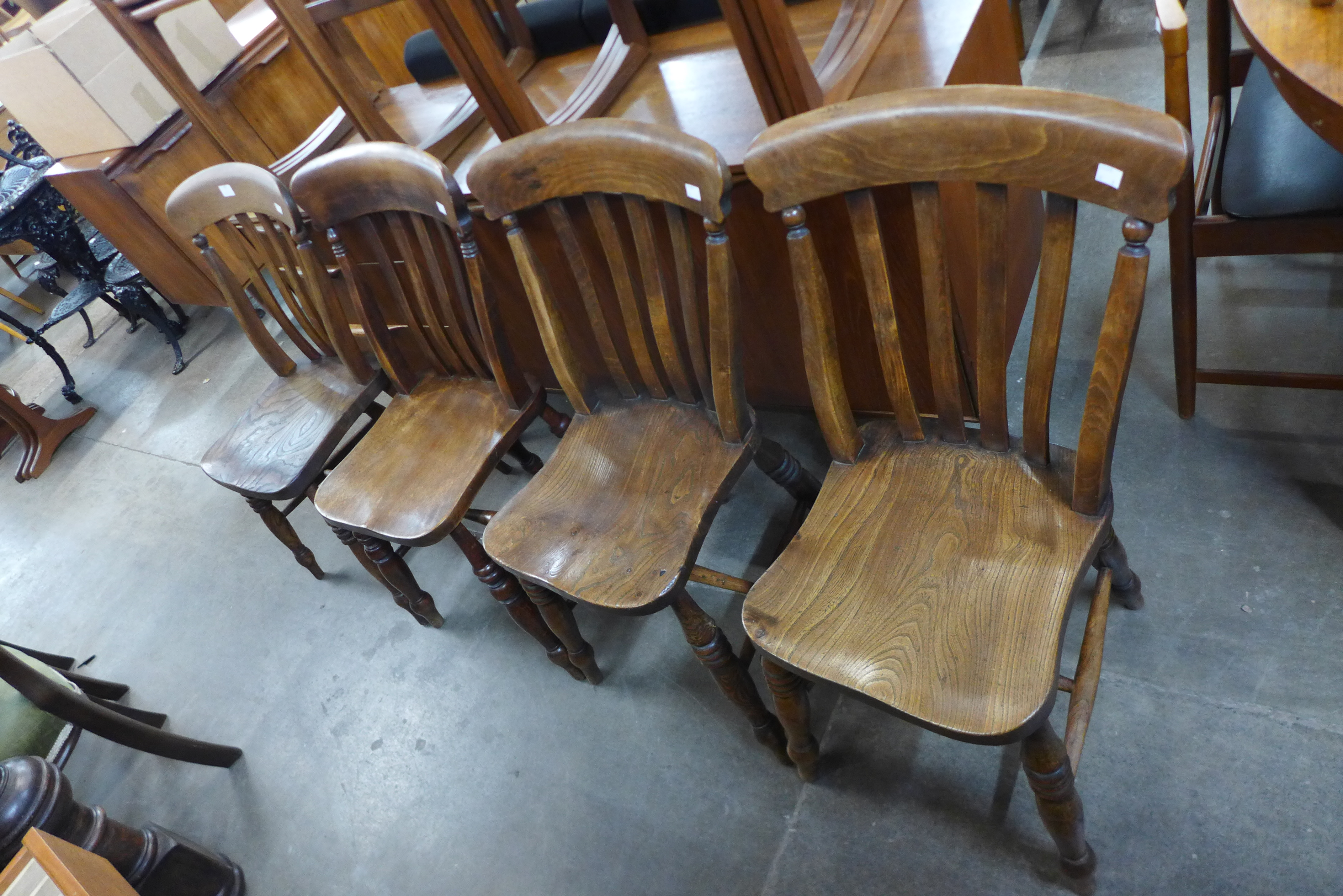 A set of four Victorian elm and beech kitchen chairs