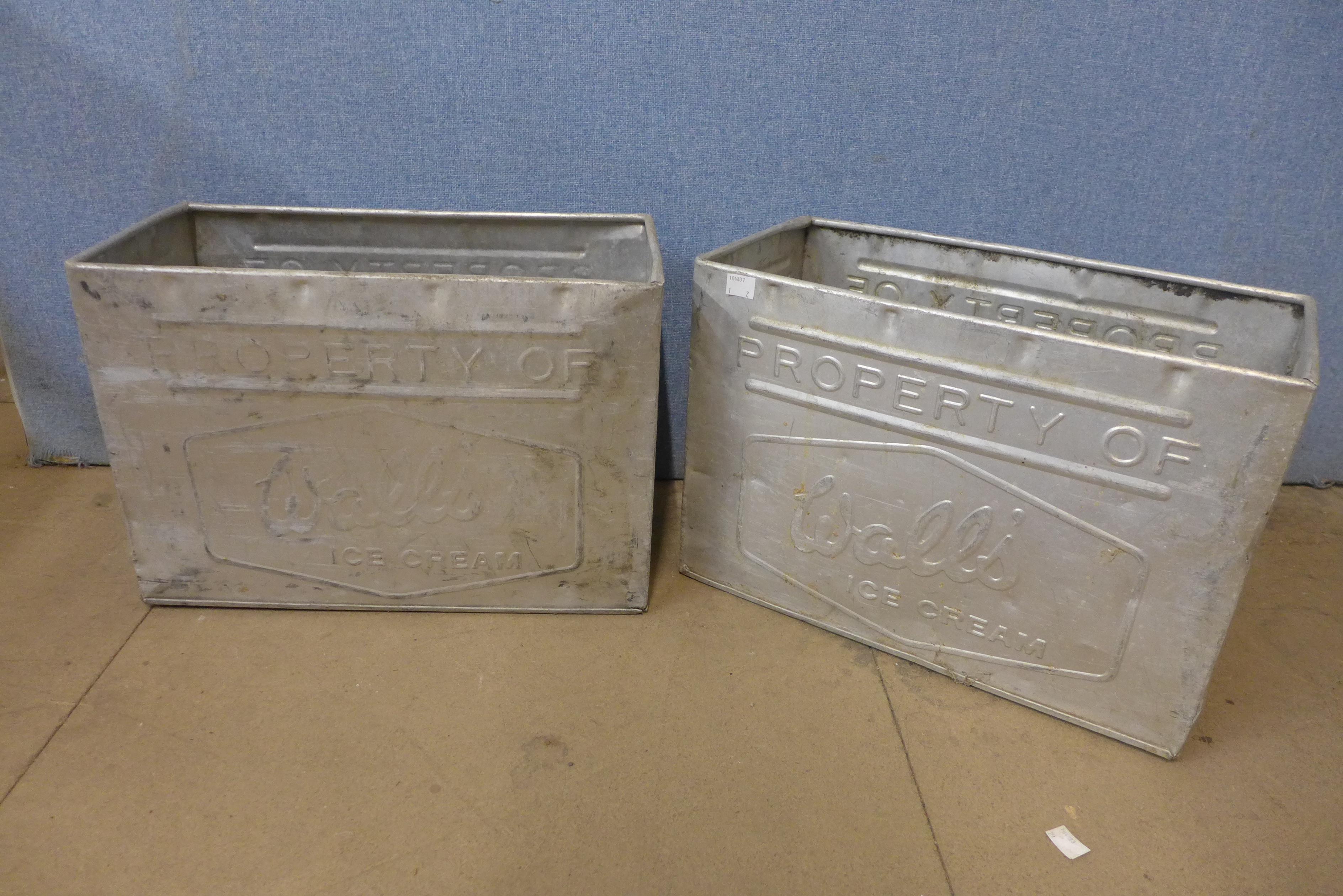 A pair of galvanised Walls Ice Cream tubs