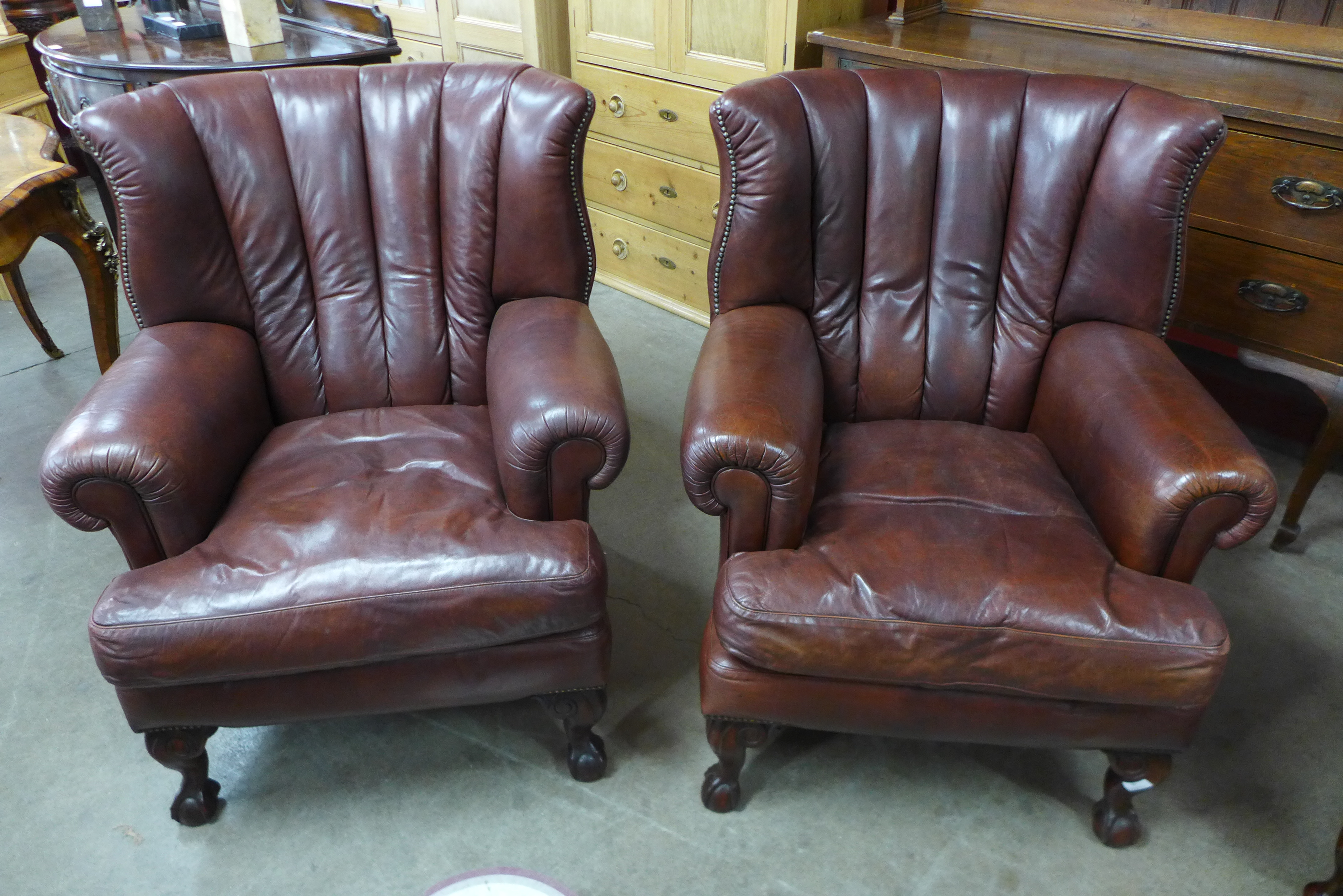 A pair of Tetrad Blake mahogany and chestnut brown leather armchairs