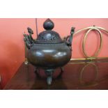 An oriental bronze two handled koro and cover, 45cm h