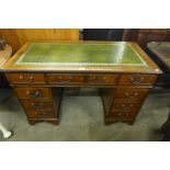 A mahogany and green leather topped pedestal desk