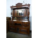 A late Victorian carved walnut mirrorback sideboard