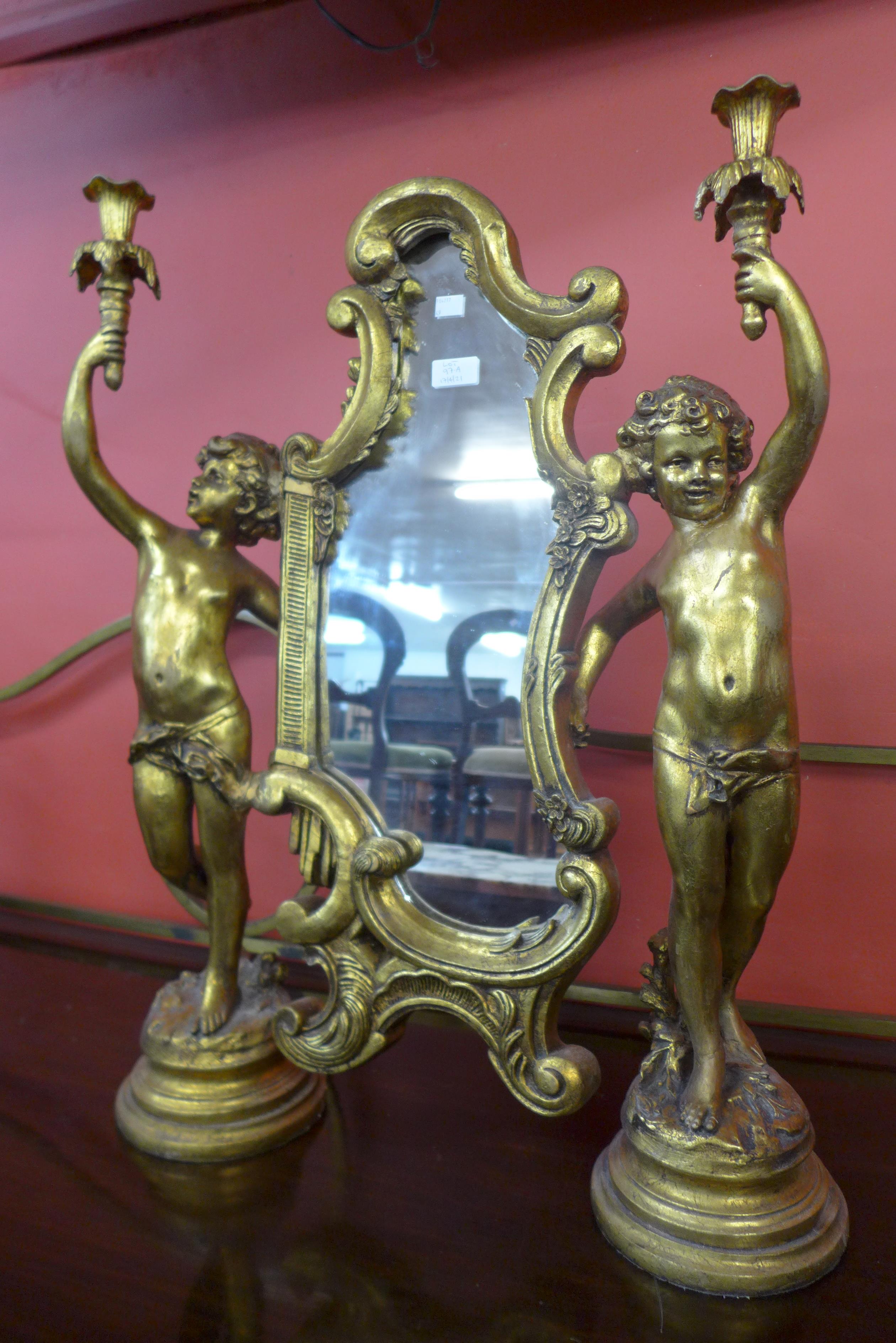 A French style gilt framed cherub dressing table mirror, 78cms h, 58cms w.