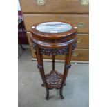 A Chinese carved hardwood and marble topped jardiniere stand, 82cms h, 32cms dia.