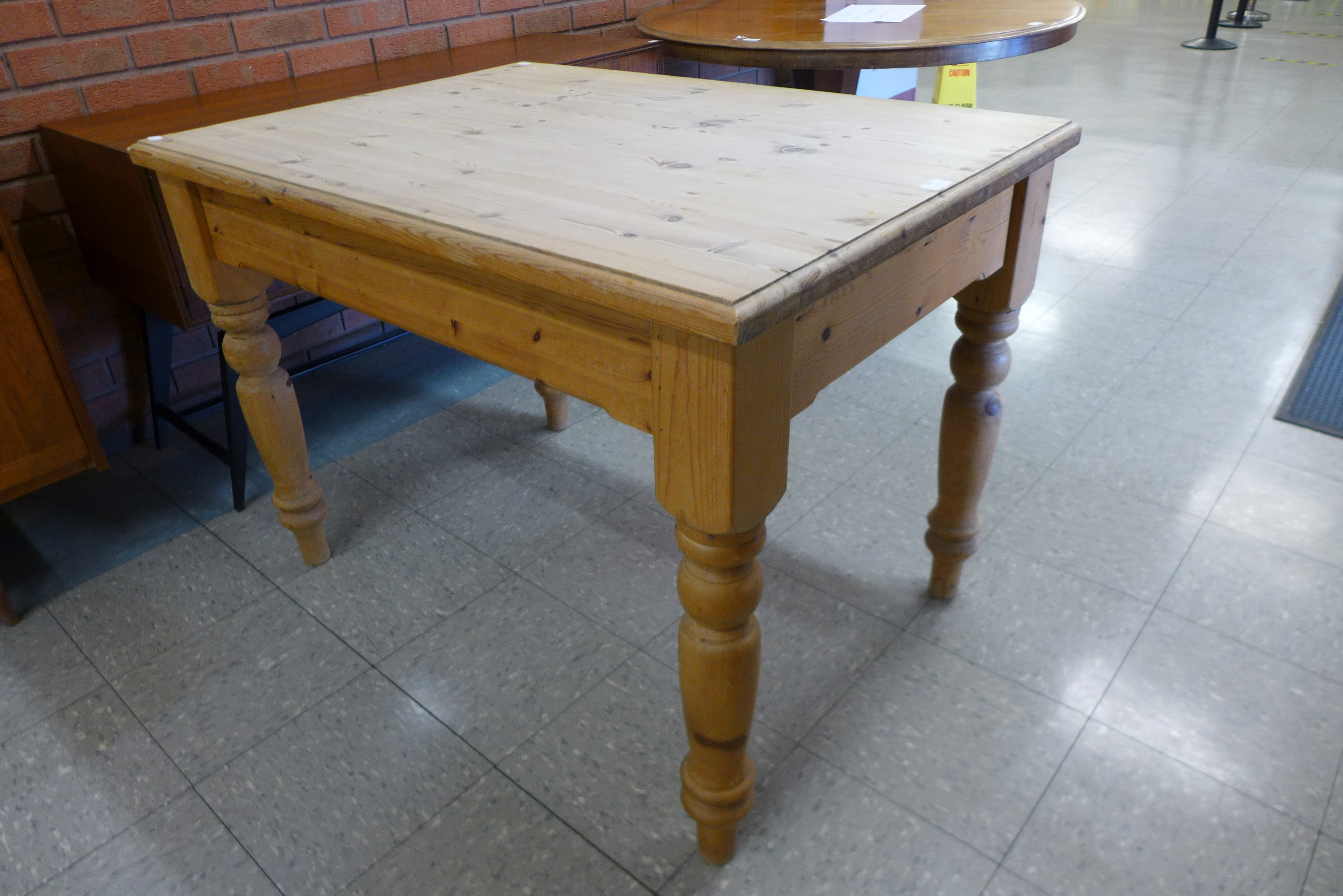 A pine single drawer kitchen table