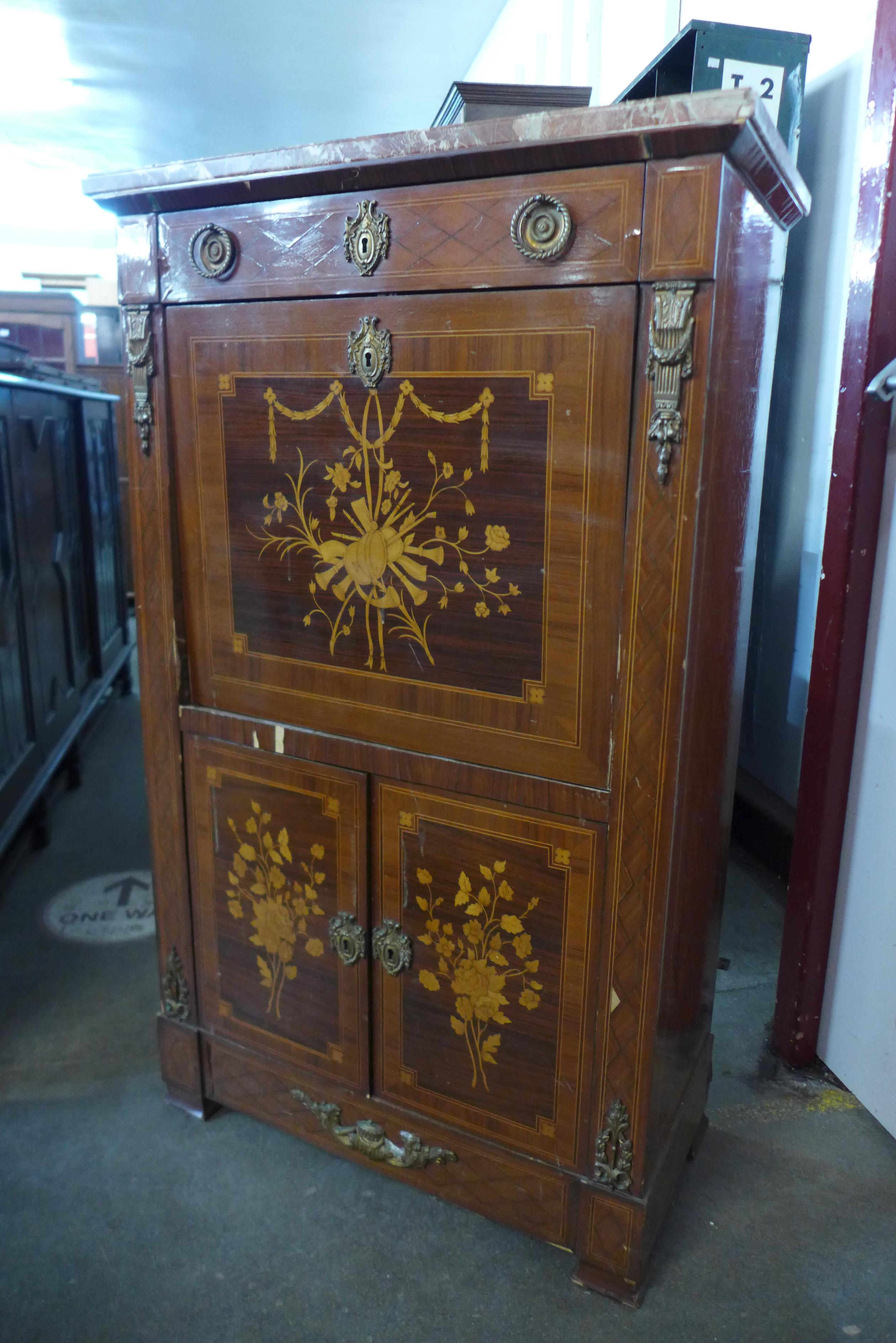 A French Louis XV style inlaid mahogany and gilt metal mounted marble topped escritoire